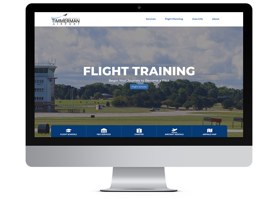 Timmerman Airport website on desktop monitor